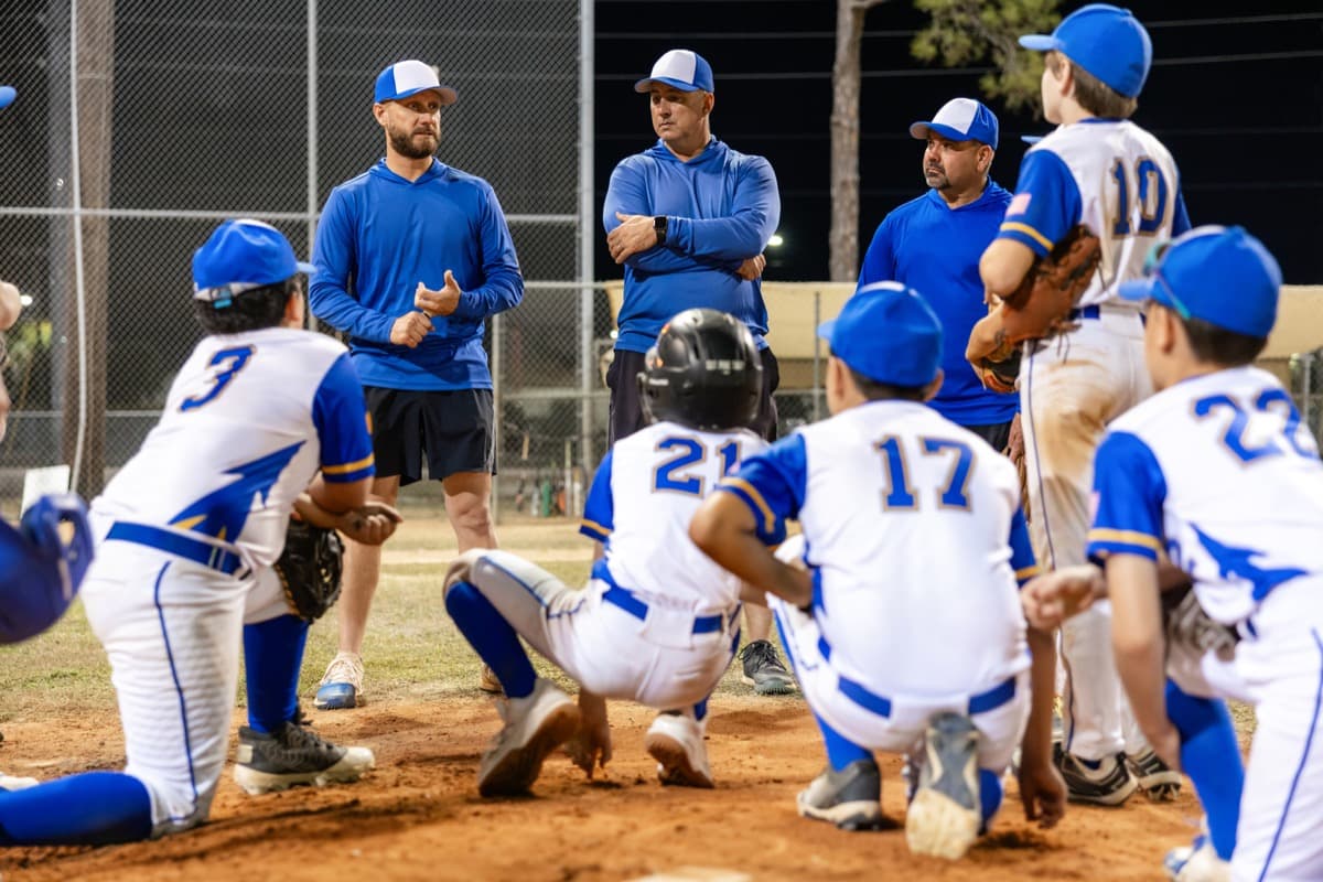 A coach talking with a youth sports team